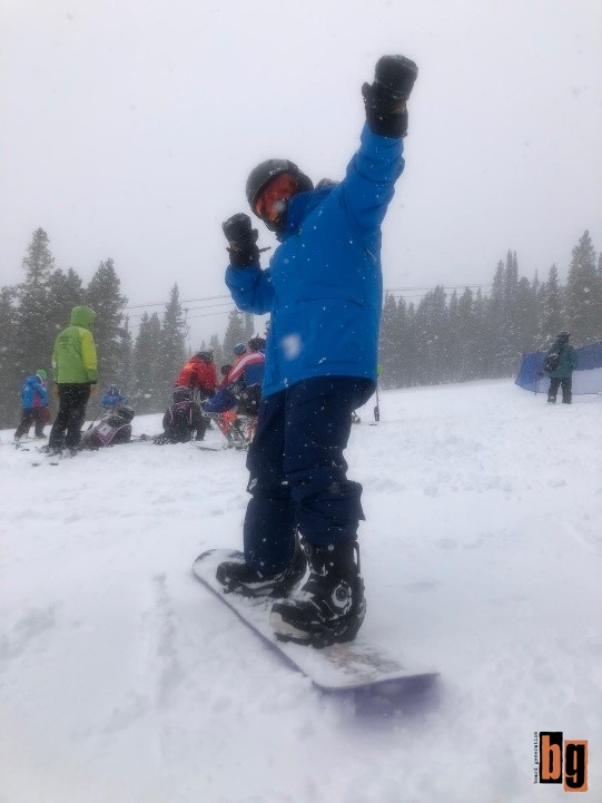 Kat posing on her snowboard