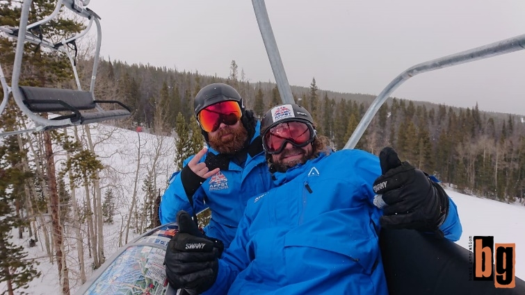 Two men posing on the chairlift